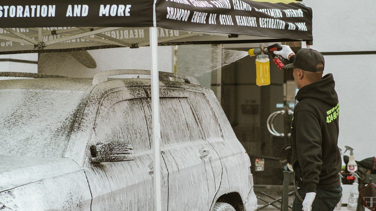 Hand wash with thick foam on a black car