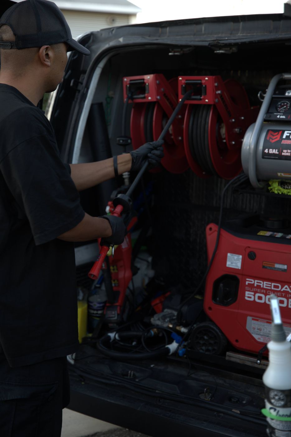 Andrew Ernacio working from the van, with the pressure washer and hose reels