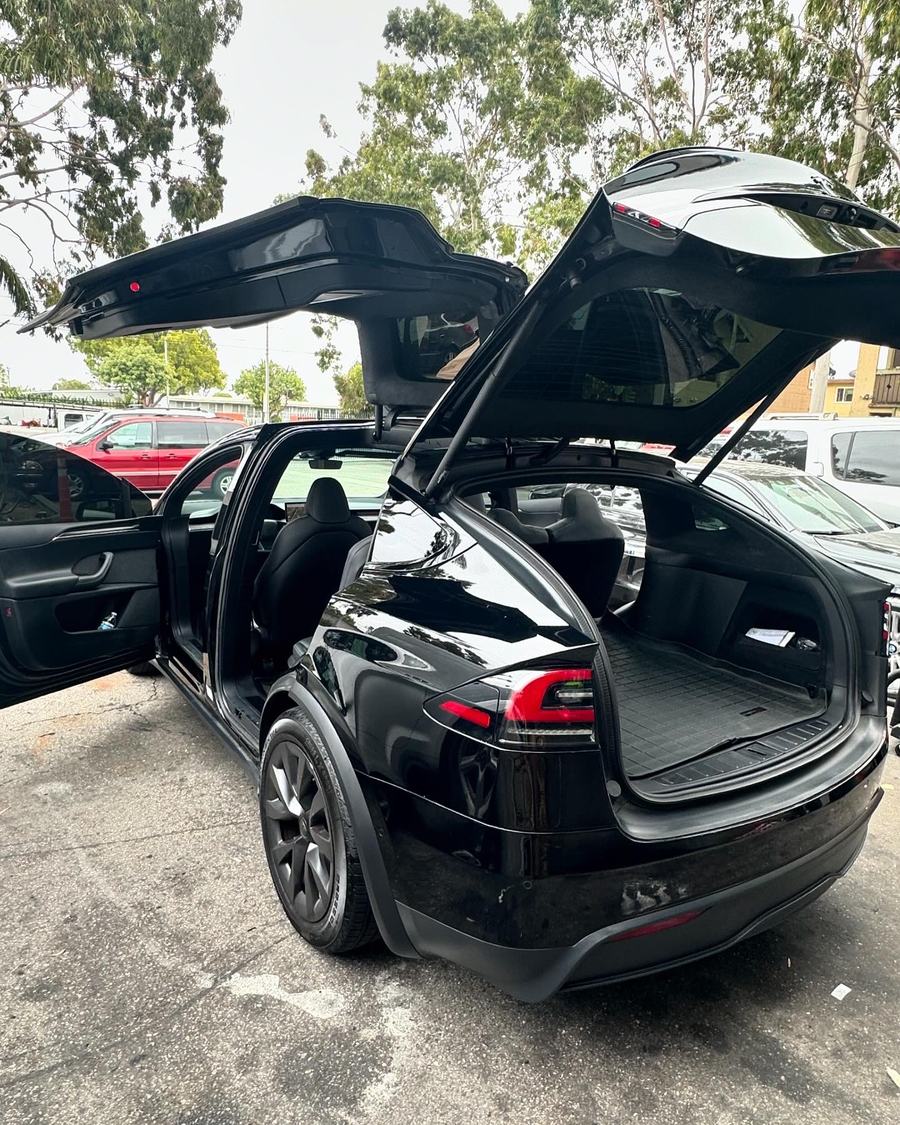 Black SUV with its rear doors raised after a full detail